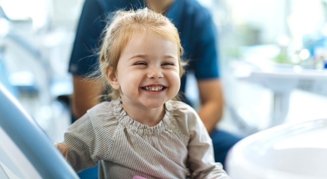 Young child smiling in dental chair at pediatric dentistry office