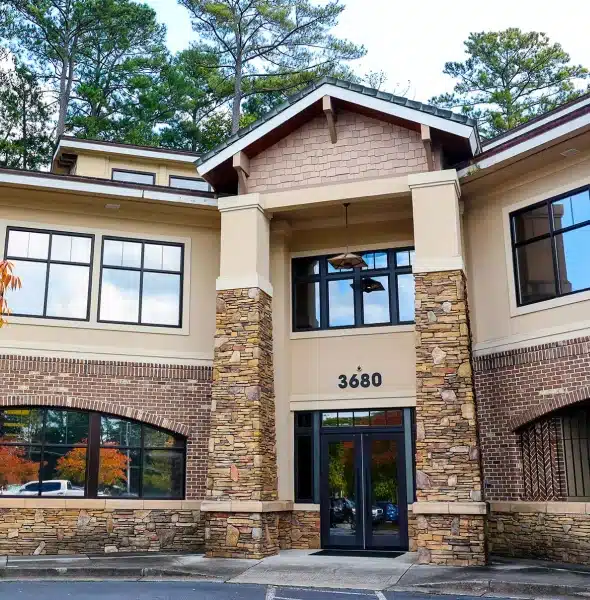 Modern pediatric dental office exterior with brick and stone facade, featuring entrance with address 3680 and professional signage.